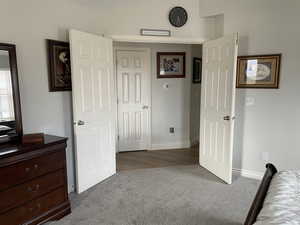 Carpeted bedroom featuring baseboards