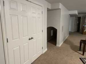 Hallway featuring carpet and hidden play room