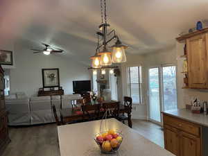 Dining space featuring lofted ceiling, light wood-style flooring, and ceiling fan