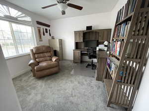 Office area with light colored carpet, baseboards, and a ceiling fan