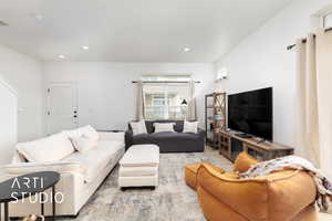 Living room with wood finished floors and recessed lighting