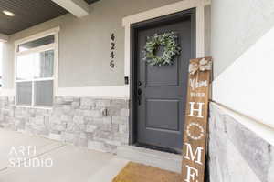 Entrance to property with stone and stucco siding