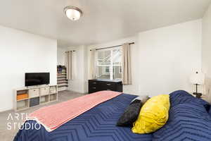 Bedroom with baseboards and carpet