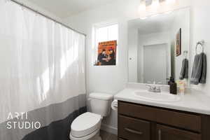 Bathroom with toilet, vanity and shower/tub combo