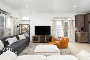 Living room featuring light wood finished floors, recessed lighting with sliding glass door to balcony