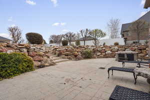 View of patio featuring fence