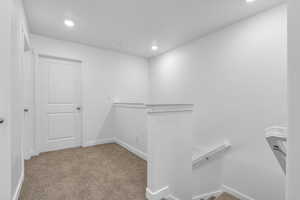 Walk in closet featuring carpet flooring