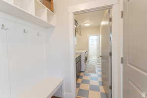 Mudroom featuring independent washer and dryer and light floors