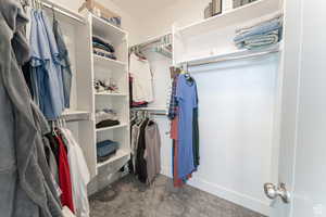 Walk in closet with carpet flooring
