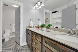 Bathroom featuring double vanity and toilet