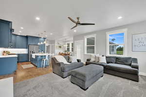 Living area featuring a ceiling fan, recessed lighting, and light wood-type flooring