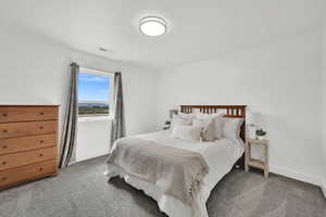 Carpeted bedroom featuring baseboards