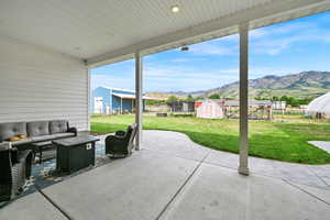View of patio featuring a storage shed, an outdoor hangout area, and a mountain view