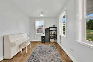 Living area with baseboards and wood finished floors