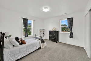 Bedroom with light carpet and baseboards