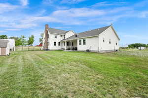Rear view of house with a patio area and a storage shed