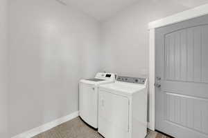 Laundry room with independent washer and dryer and light floors
