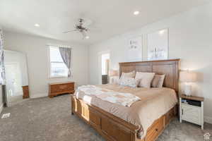 Carpeted bedroom featuring baseboards, visible vents, recessed lighting, and a ceiling fan