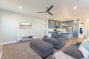 Living room featuring baseboards, ceiling fan, and recessed lighting