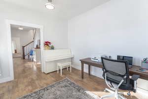 Office space featuring baseboards and wood finished floors