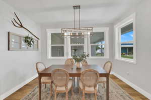 Dining space featuring a chandelier and wood finished floors