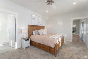Bedroom featuring baseboards, recessed lighting, a ceiling fan, and light carpet