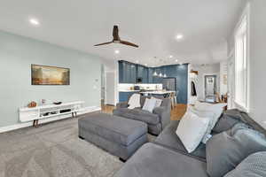 Living room with ceiling fan and recessed lighting