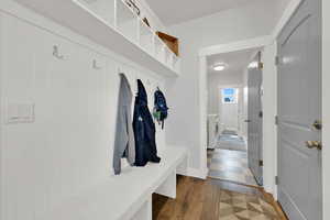 Mudroom featuring independent washer and dryer and dark wood-type flooring