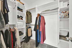 Spacious closet featuring carpet floors