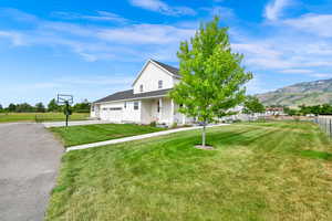View of front facade featuring an attached garage, driveway, and a mountain view