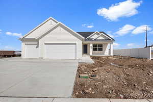 View of front of home featuring concrete driveway, fence, a garage, board and batten siding, and a porch