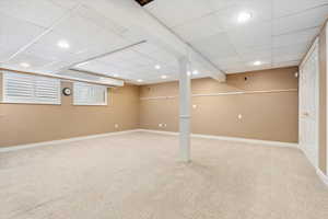 Finished below grade area featuring baseboards, recessed lighting, and carpet