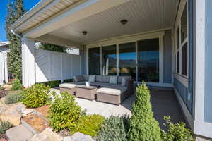 View of patio featuring an outdoor hangout area and fence