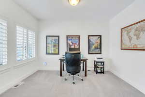 Office with carpet flooring, baseboards, and visible vents