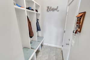Mudroom featuring baseboards and light tile patterned floors