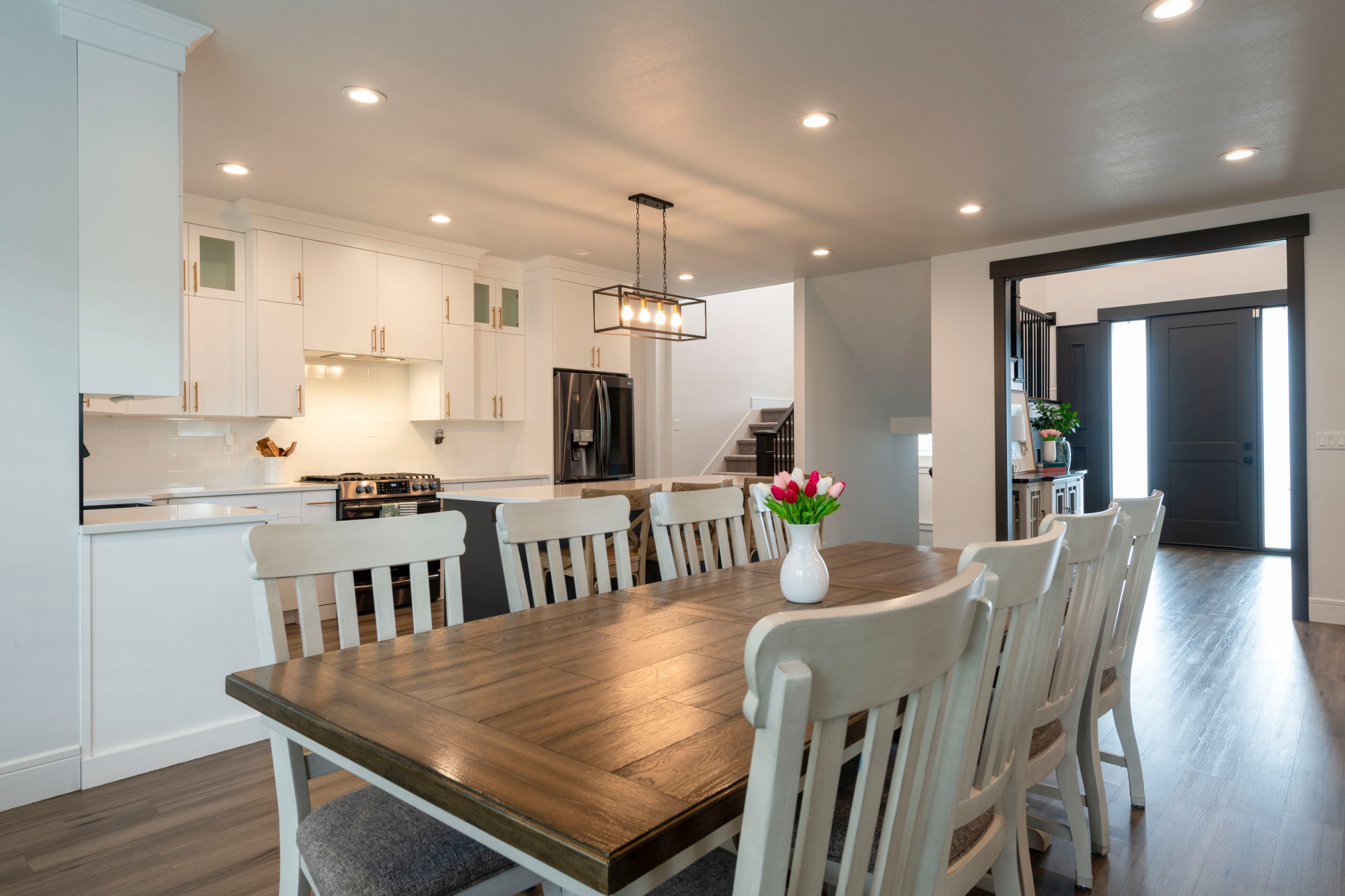 Dining space with stairs, recessed lighting, and dark wood finished floors