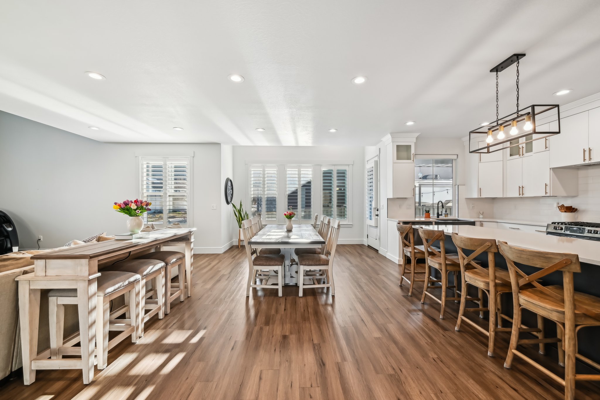 Dining space with wood finished floors, baseboards, and recessed lighting
