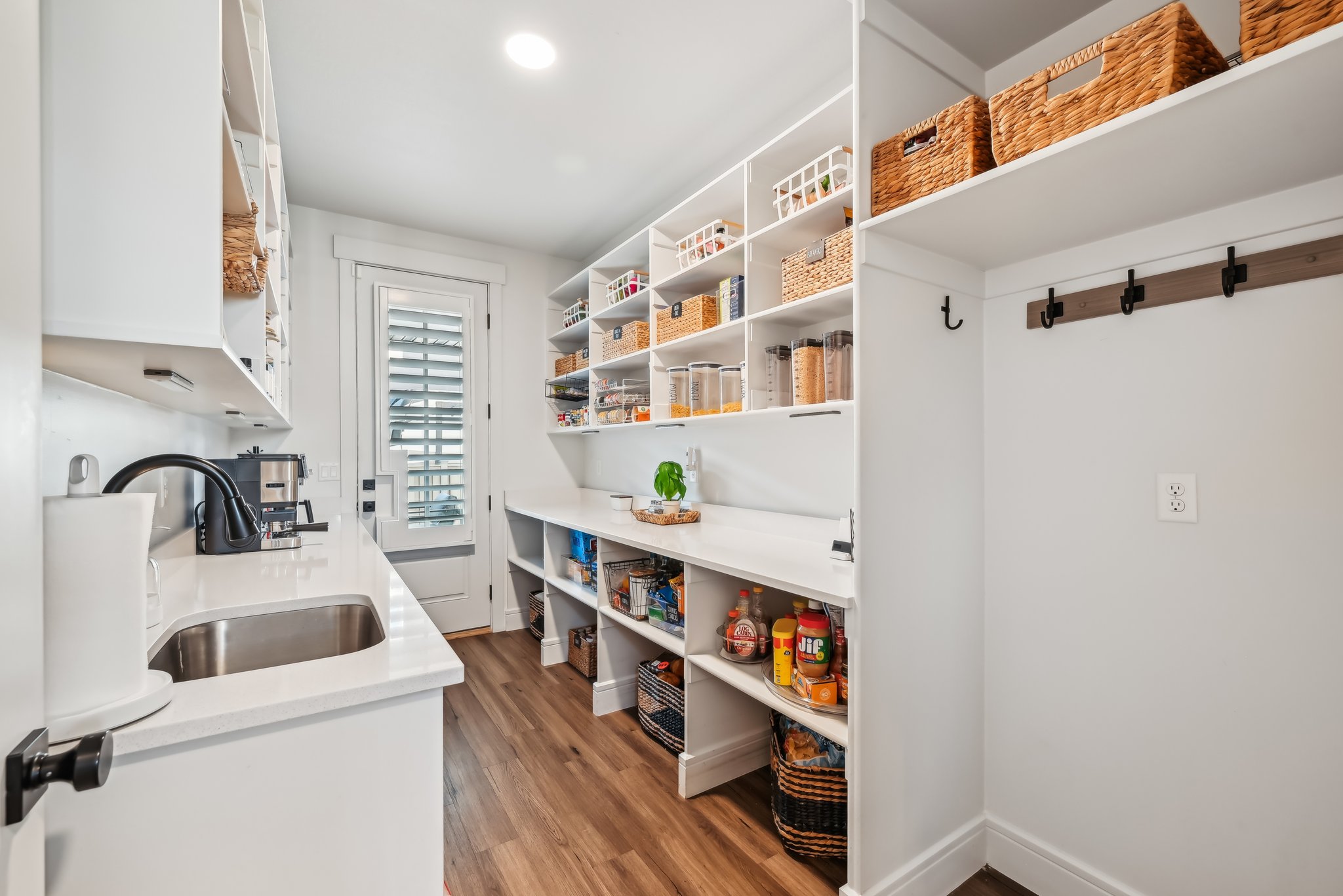 Walk in pantry! Behind the wall of cabinets with the fridge