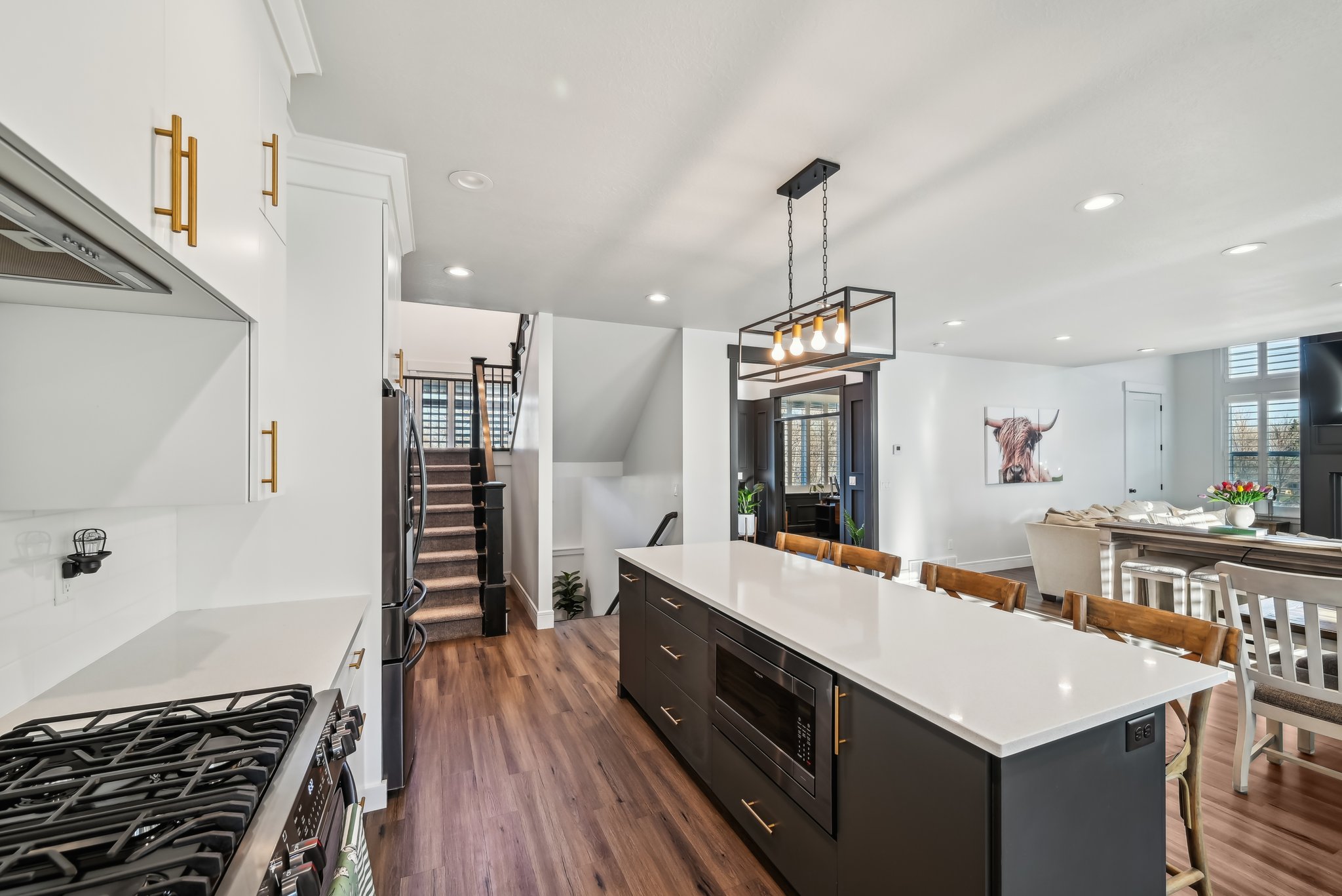 Kitchen with a center island, white cabinets, a breakfast bar, and appliances with stainless steel finishes