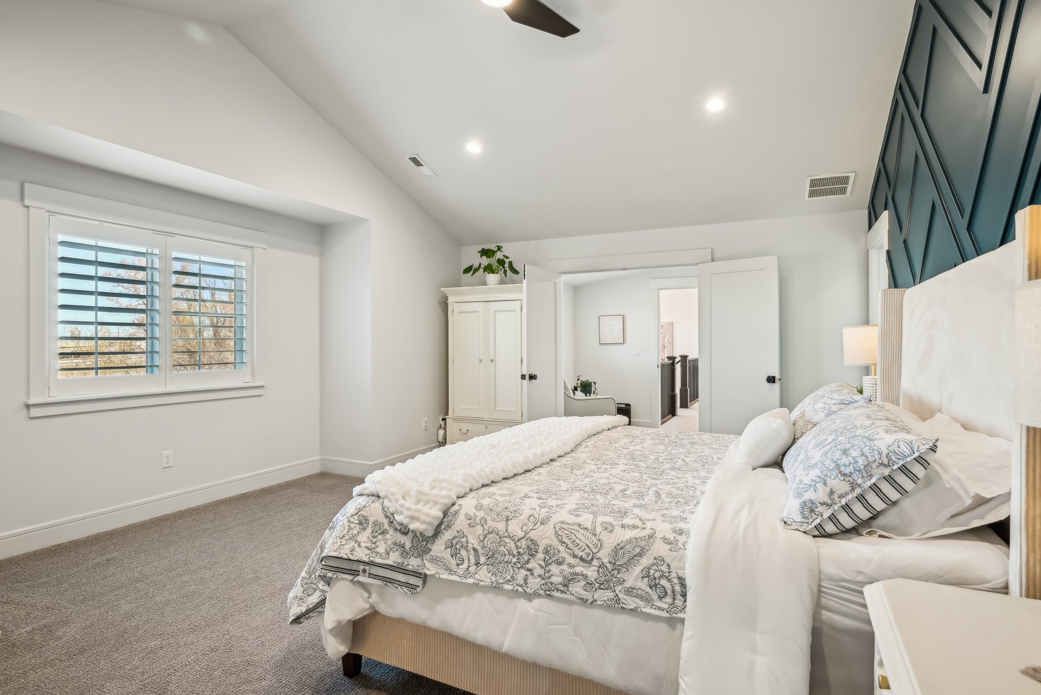 Bedroom with baseboards, recessed lighting, visible vents, lofted ceiling, and carpet