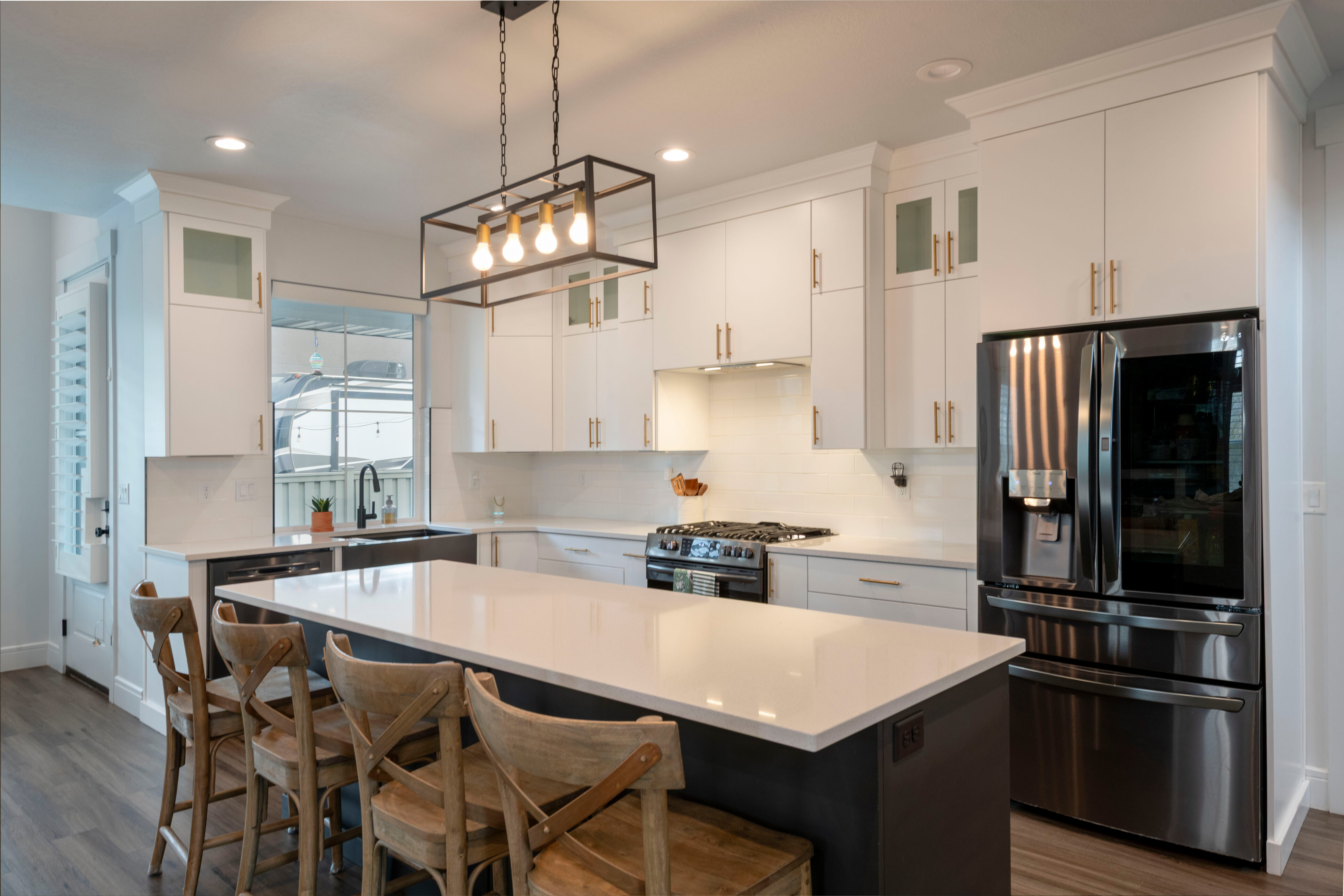 Kitchen featuring light countertops, a sink, stainless steel appliances, and decorative backsplash