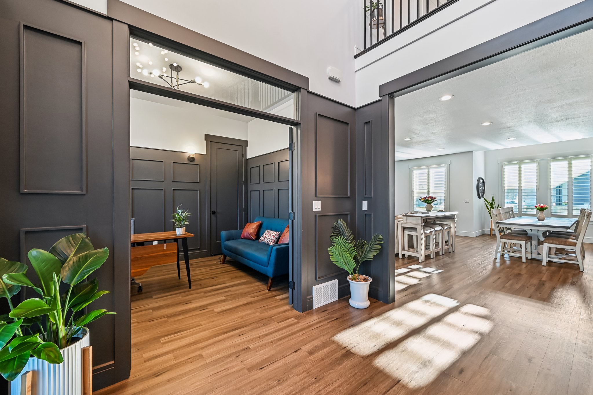 Interior space with a decorative wall, visible vents, and light wood-style flooring