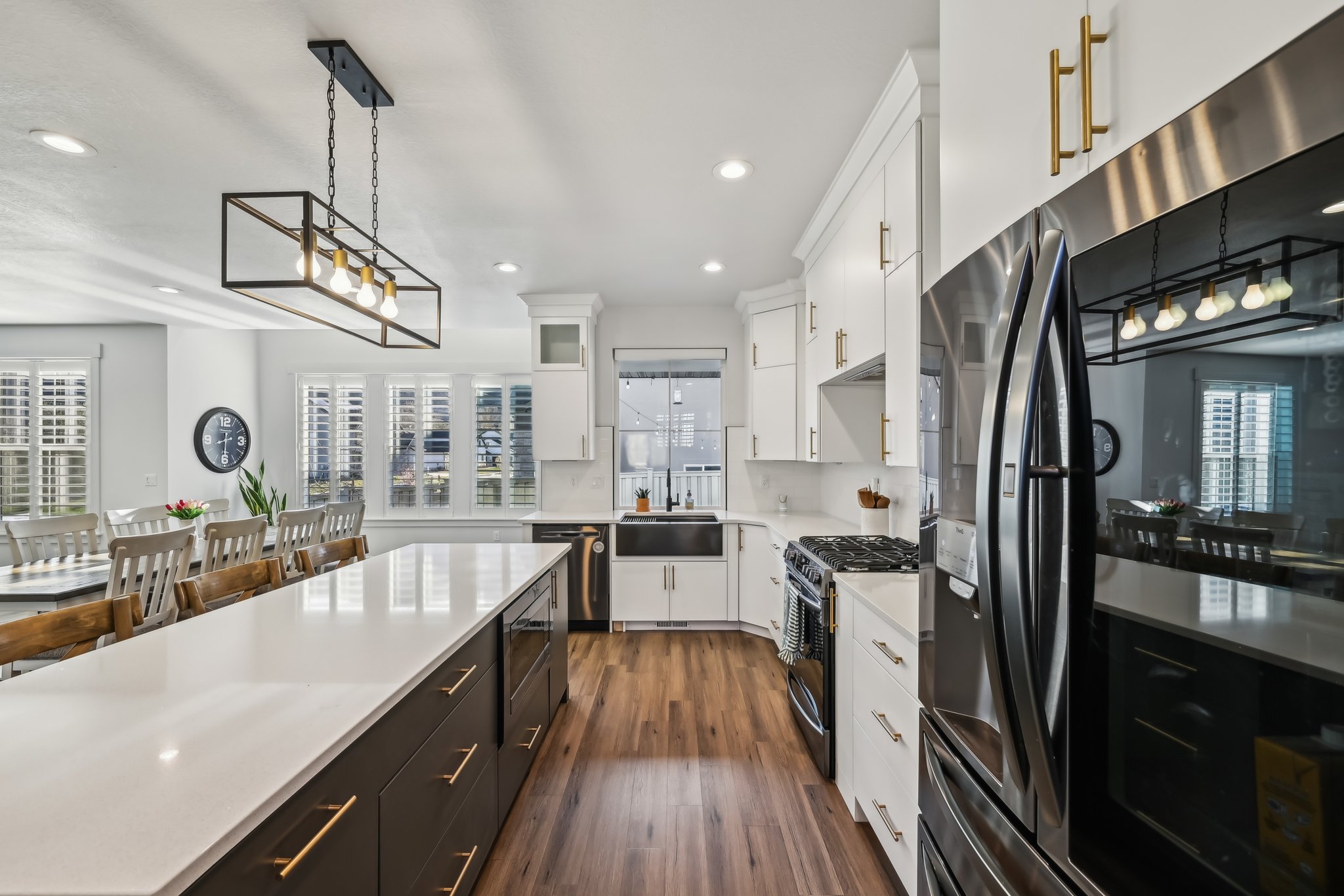 Kitchen featuring plenty of natural light, gas range, light countertops, white cabinetry, and recessed lighting