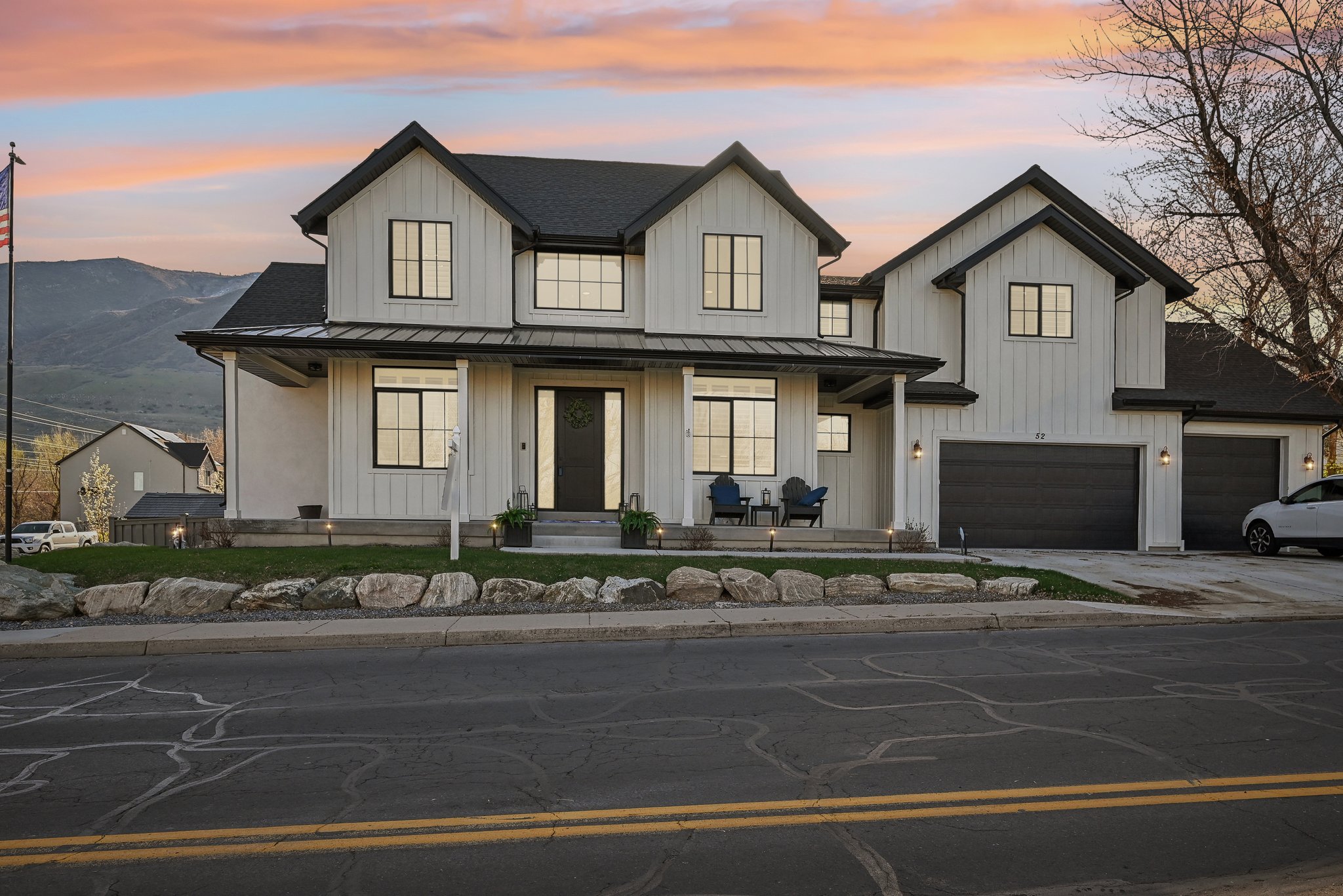 Modern farmhouse featuring a standing seam roof, metal roof, and board and batten siding