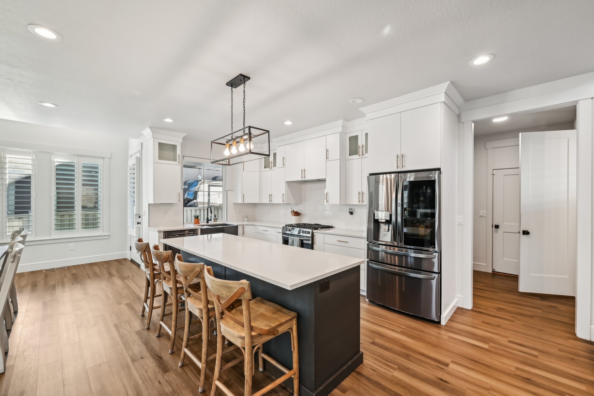 Kitchen with a sink, light countertops, appliances with stainless steel finishes, and light wood finished floors