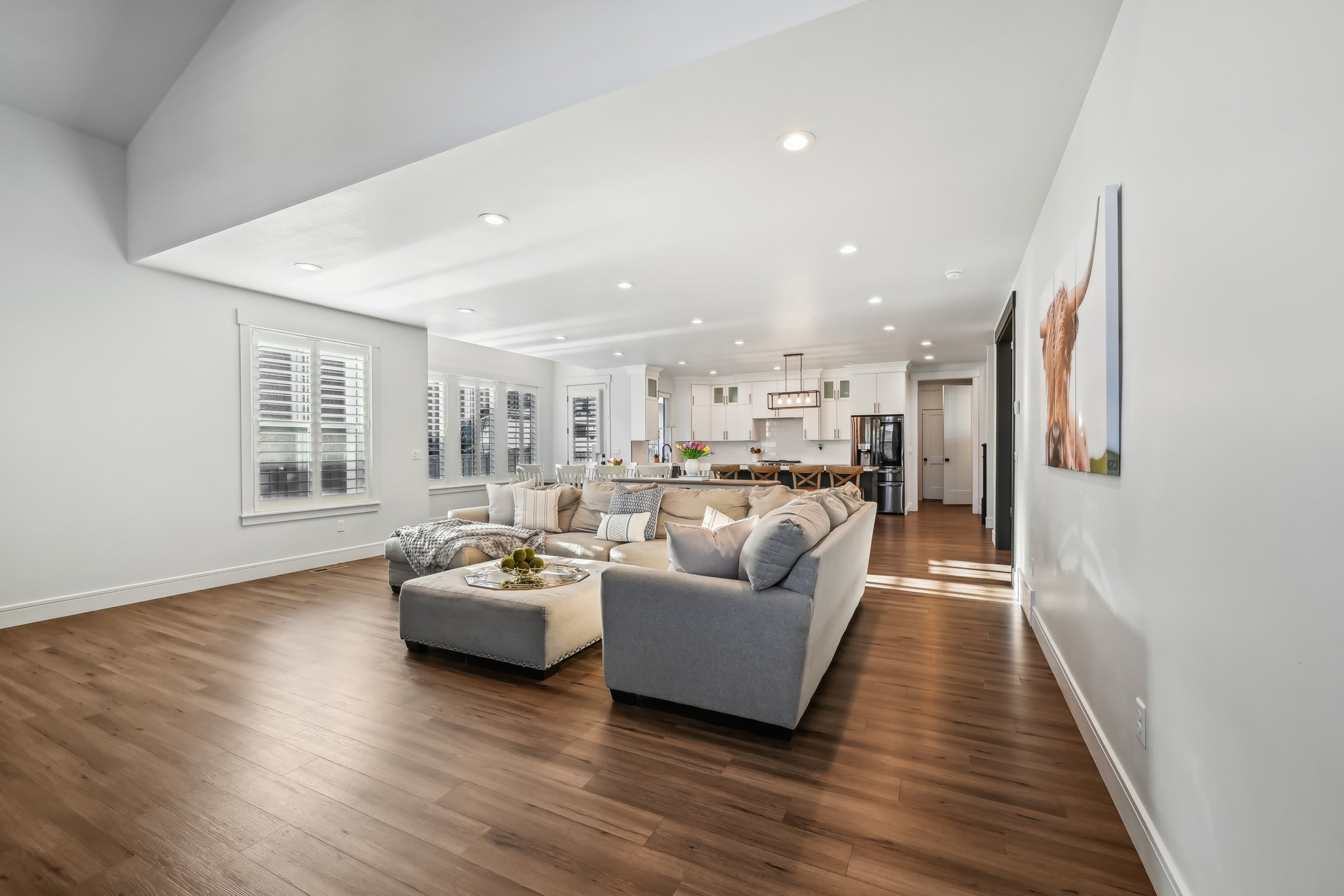 Living area with recessed lighting, dark wood-type flooring, and baseboards