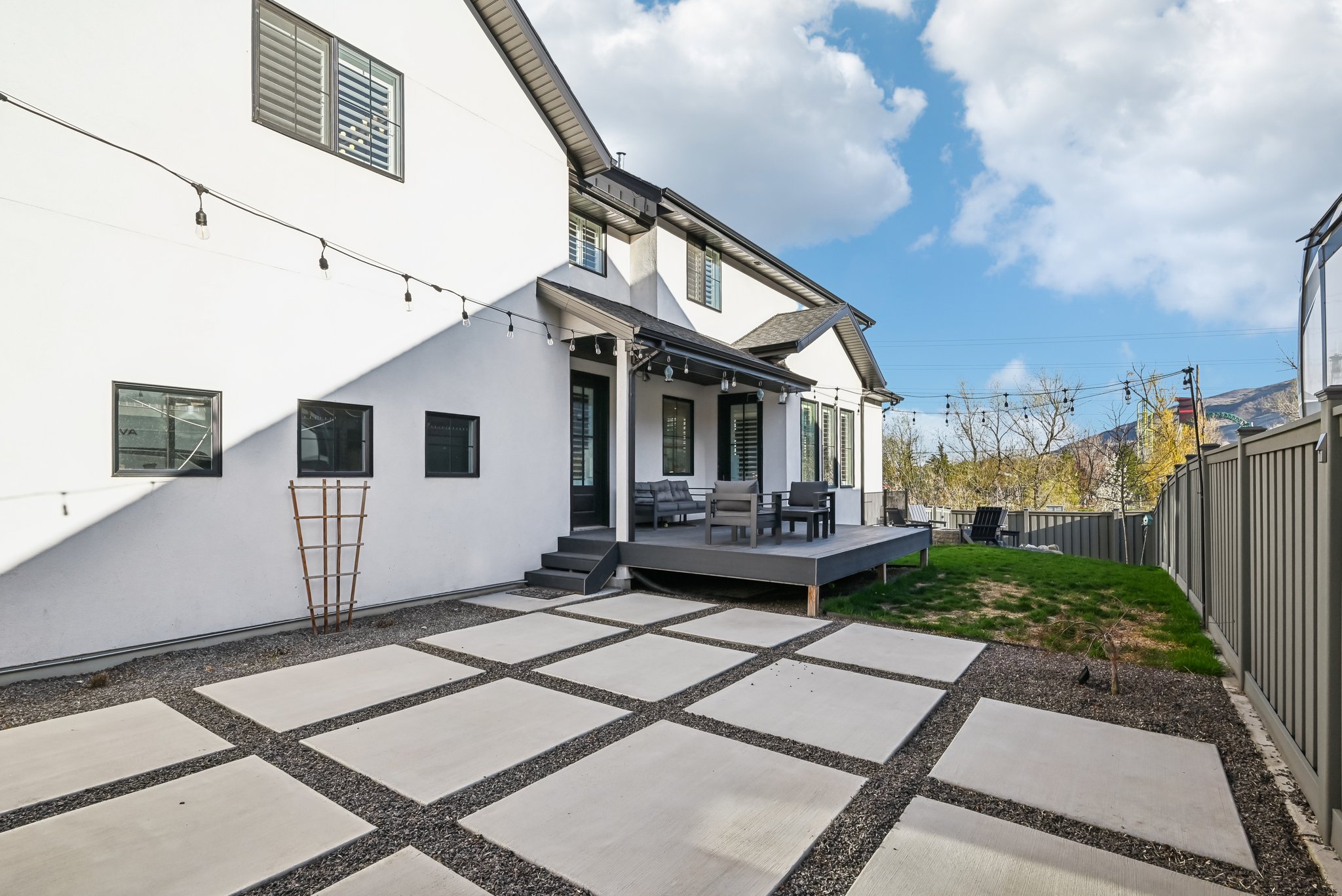 Rear view of property with a patio area, a fenced backyard, and stucco siding
