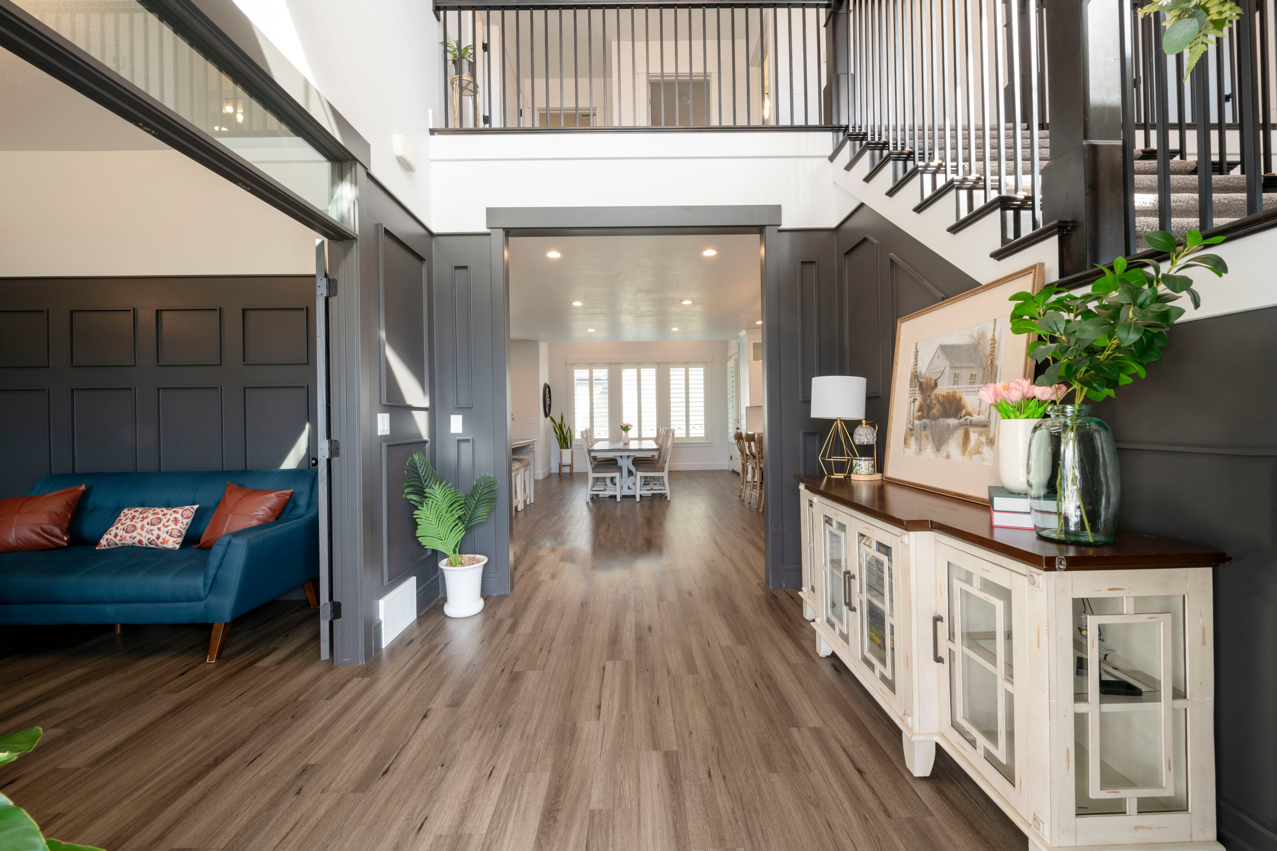 Entryway with a high ceiling, stairs, and wood finished floors