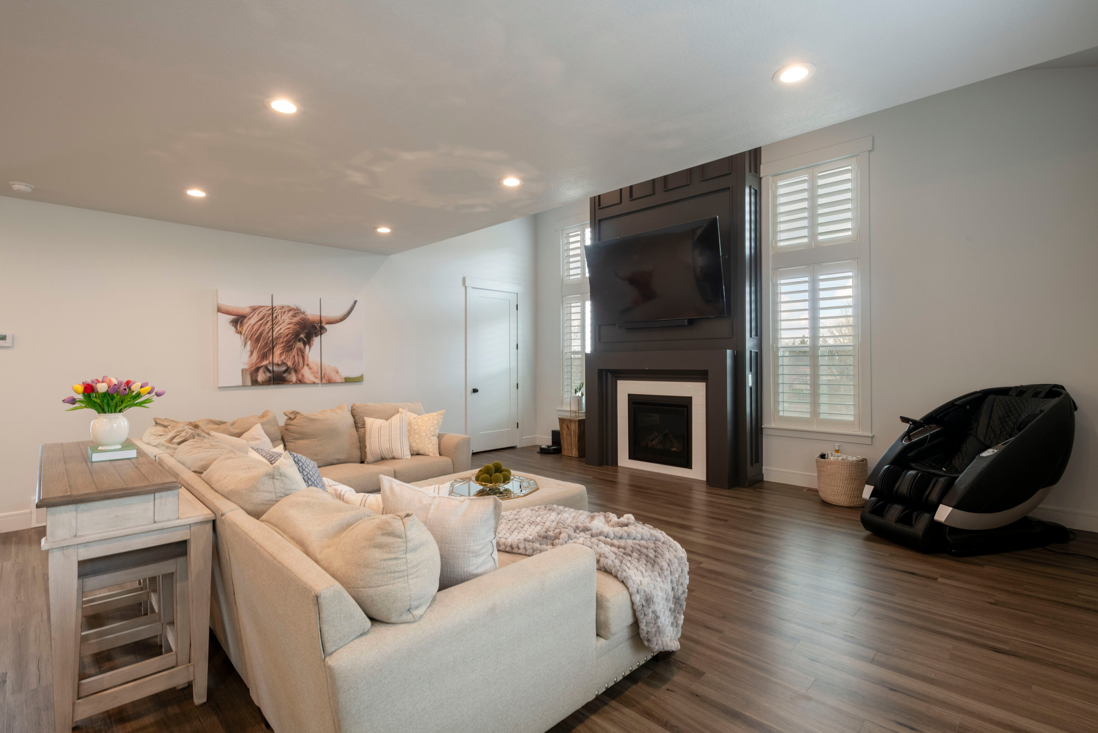 Living area with baseboards, a large fireplace, recessed lighting, and dark wood-style flooring
