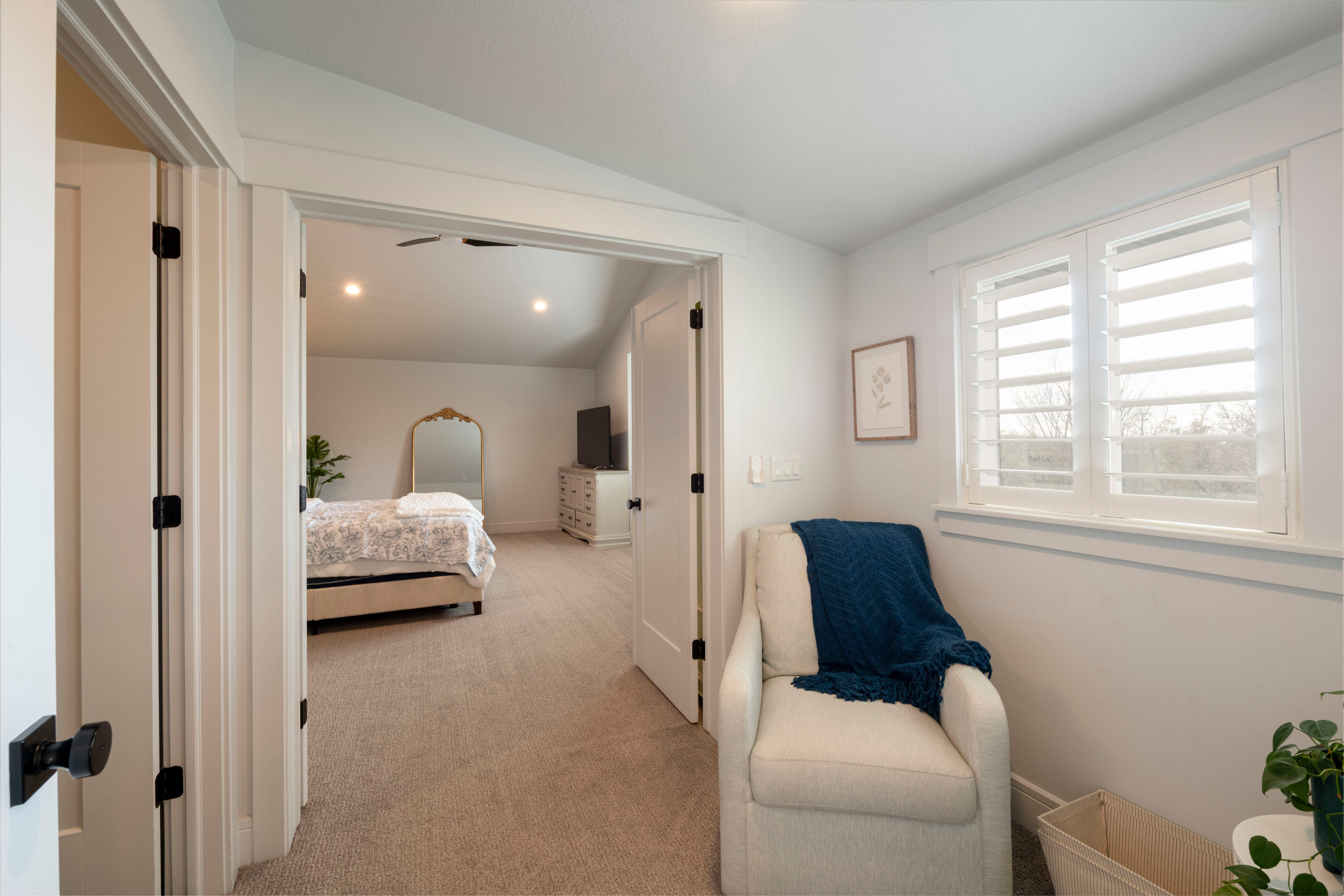 Bedroom with light carpet, baseboards, and lofted ceiling